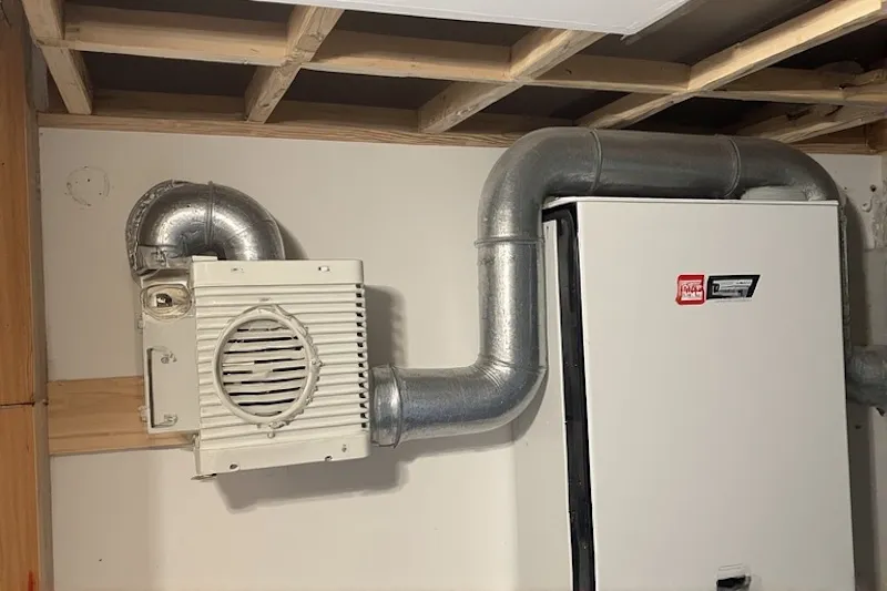 Compact ERV unit installed in a residential attic space, demonstrating a common home application